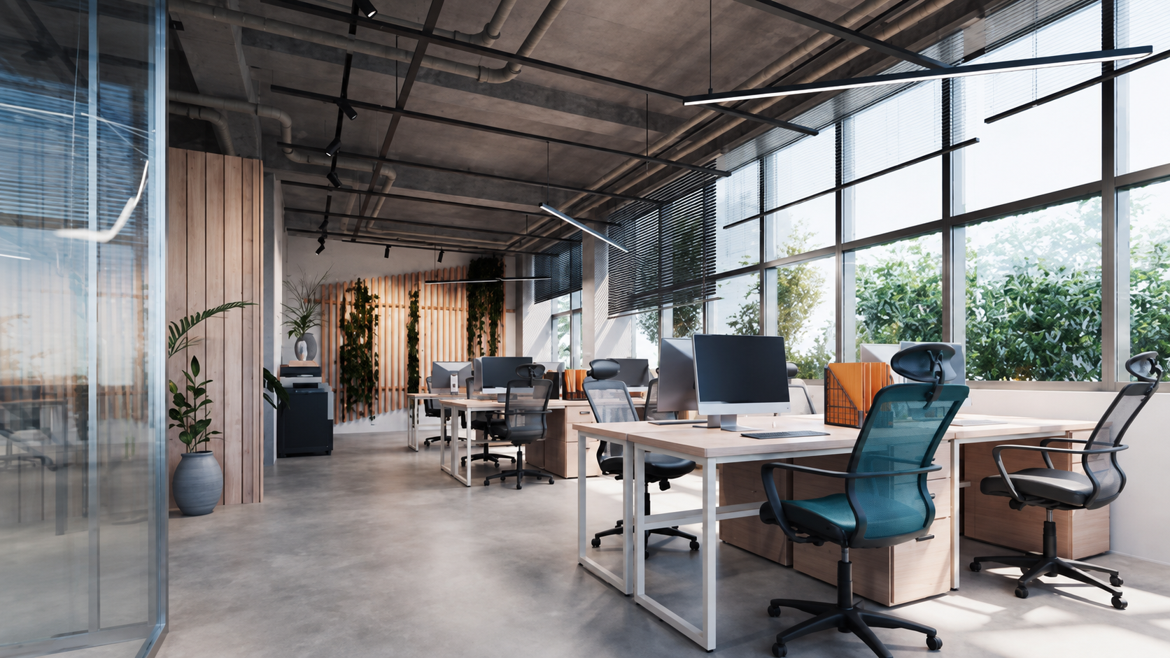 Bright modern office with desks, plants, and floor-to-ceiling windows